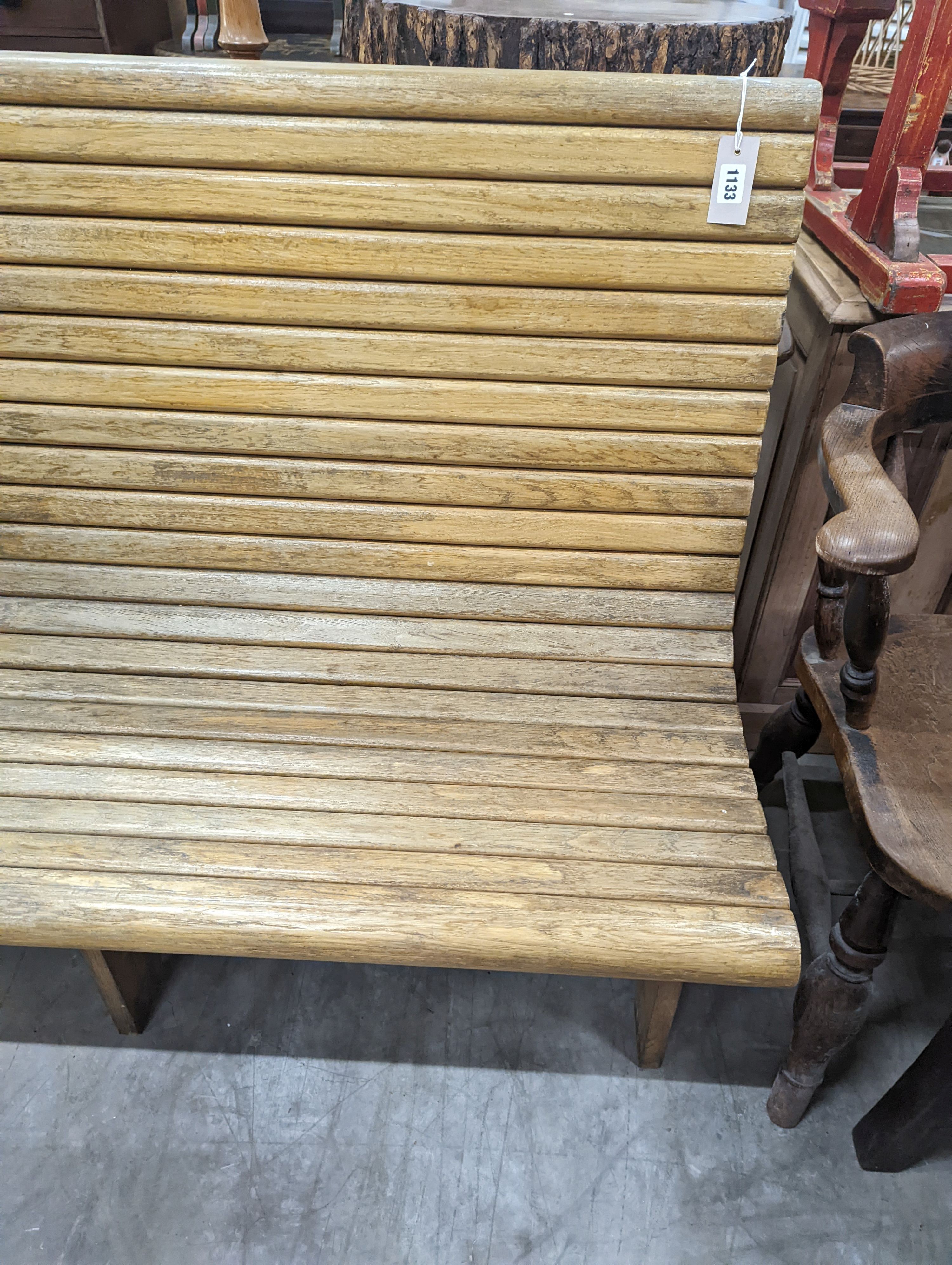 A vintage slatted wood tram bench, length 140cm, depth 60cm, height 98cm